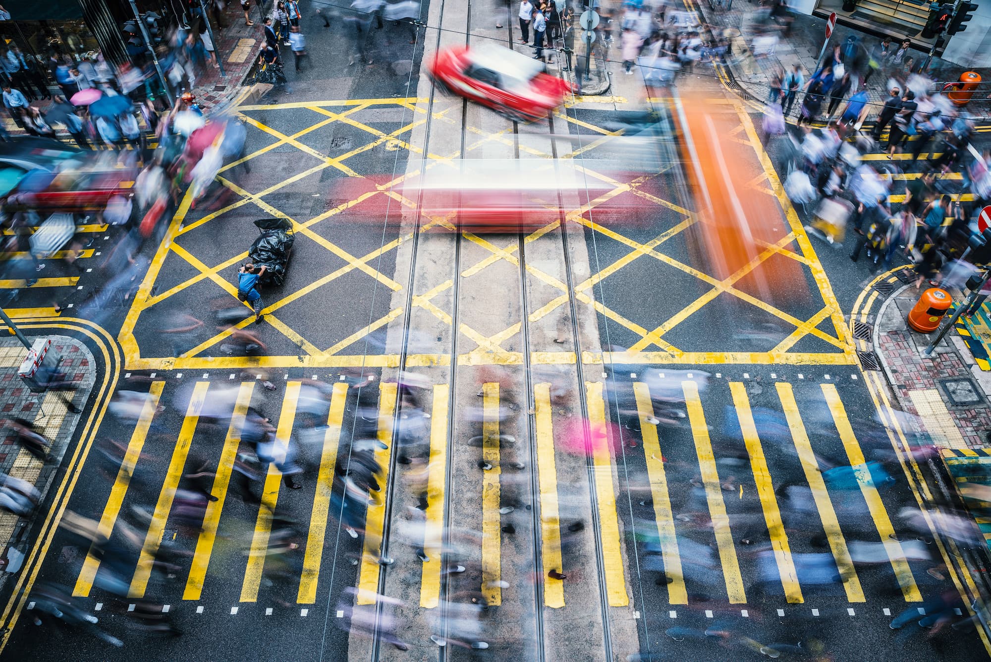 People walking across a crowded street