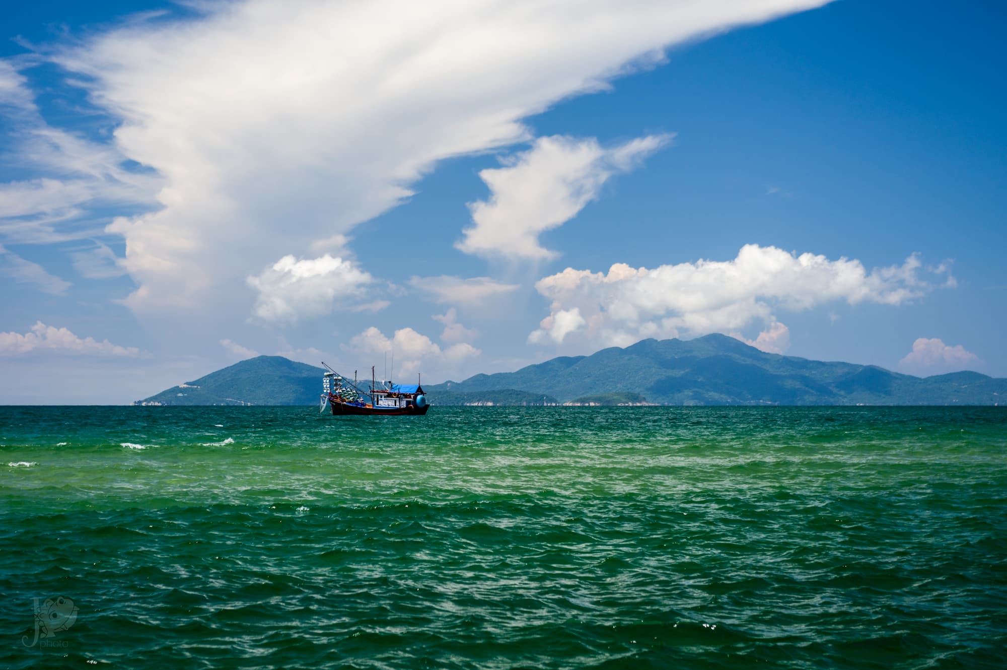 A boat sails across the ocean