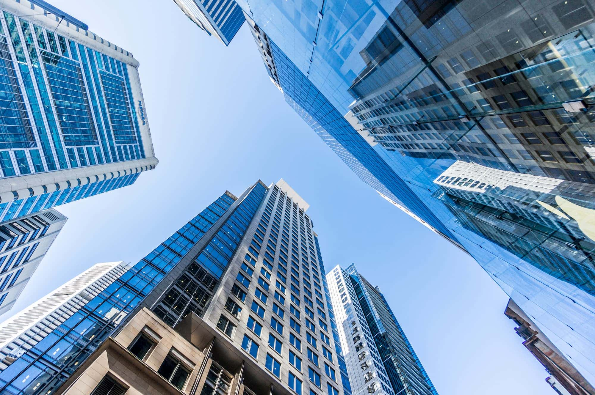 A view looking up at towering city buildings