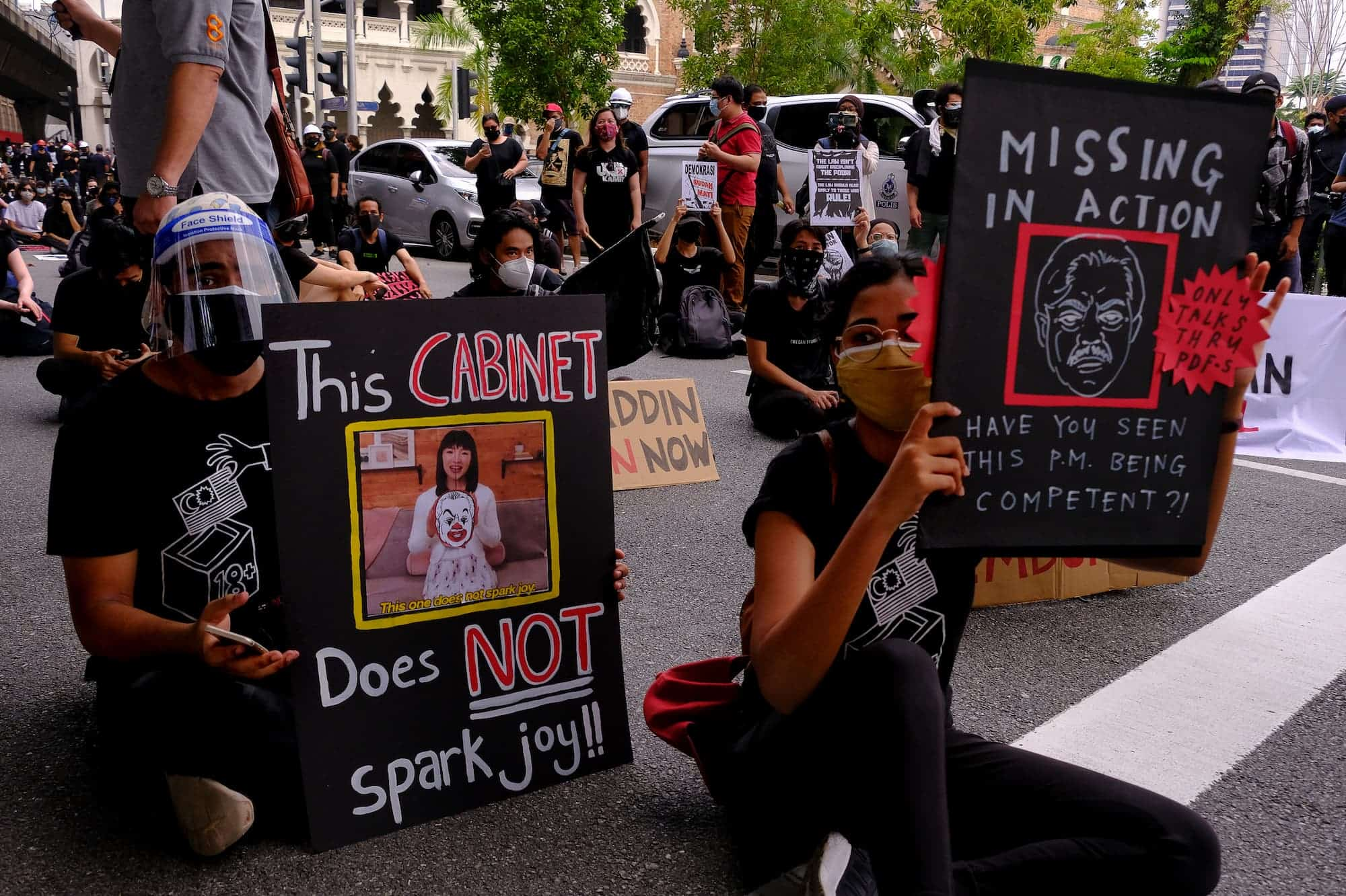 Protesters display placards at a rally