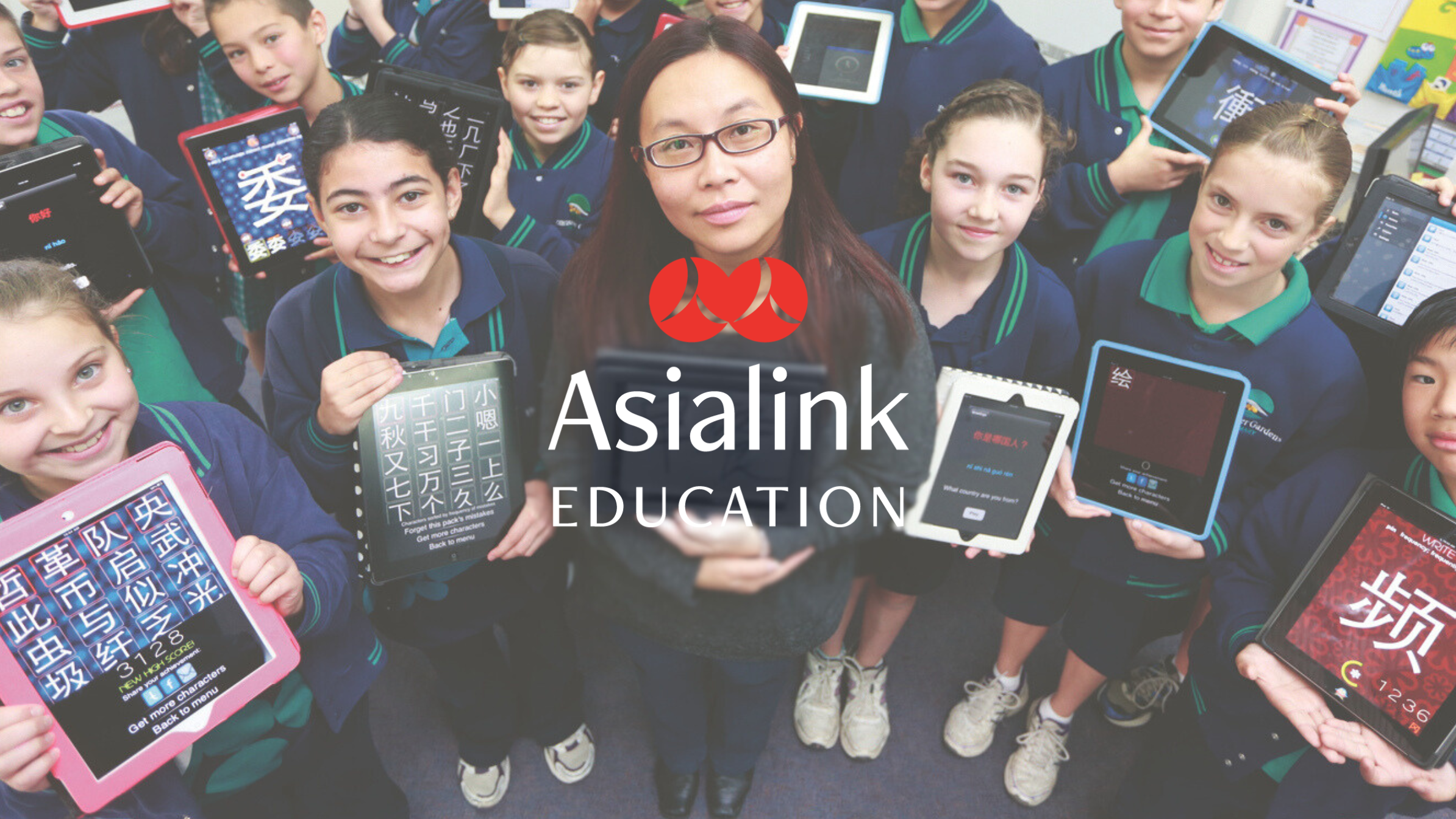 A group of students and a teacher hold tablets. 