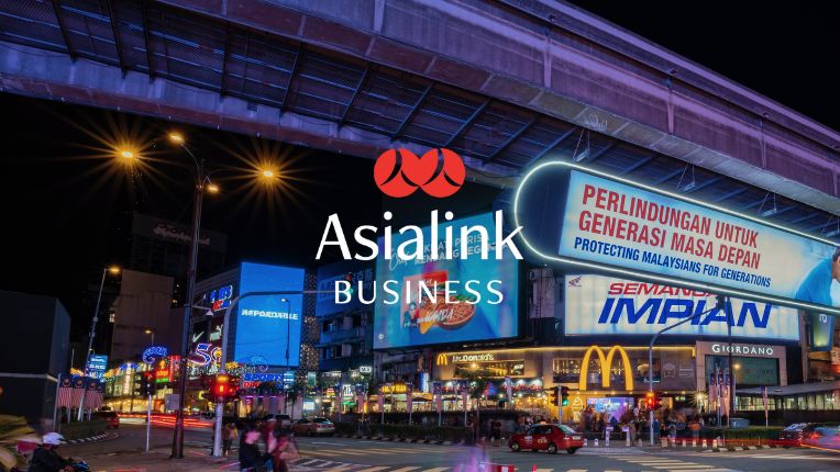 Busy street corner under flyover at night in Malaysia