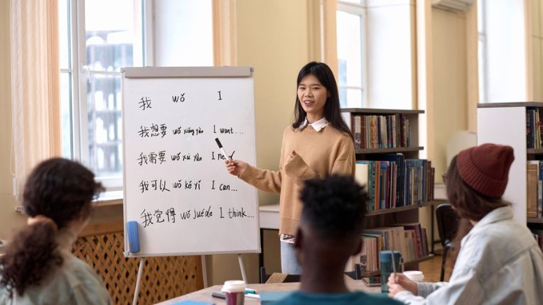 Asian woman teaching Chinese to students