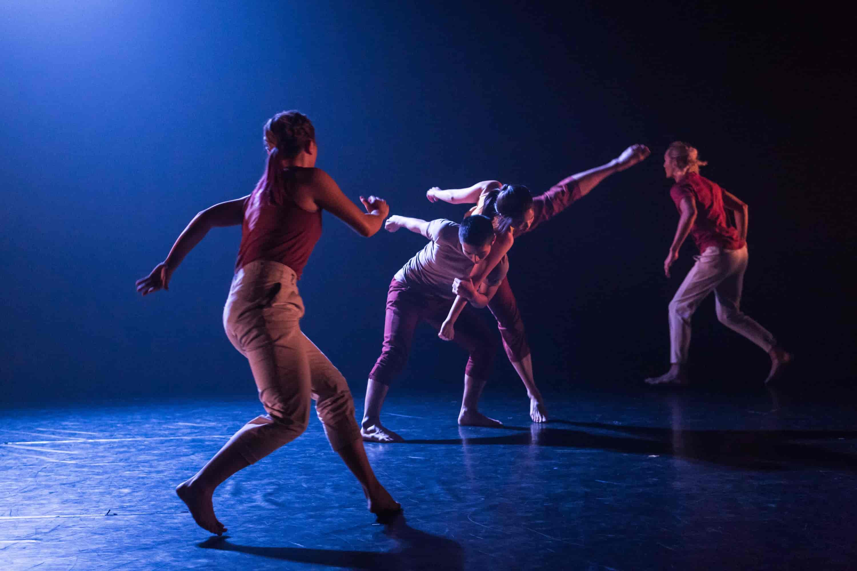 Four dancers peforming on a stage