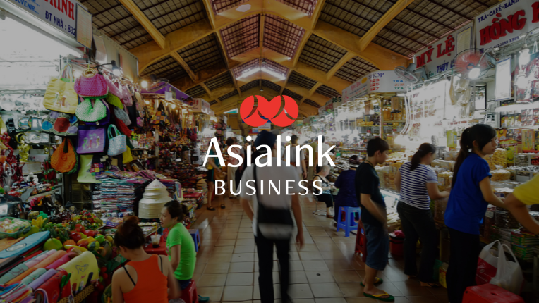 Laos market with Asialink Business logo overlayed.