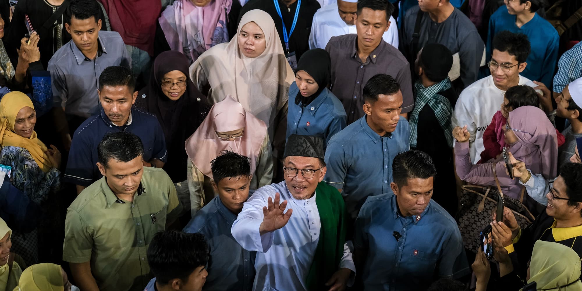 Malaysia's Prime Minister Anwar Ibrahim waves his hand to the crowd