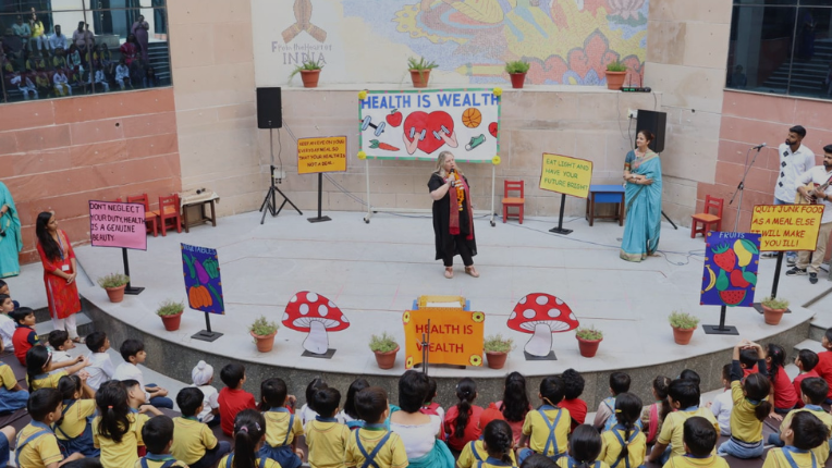 Australian teacher in India presenting in school assembly