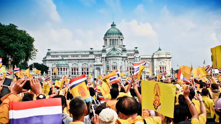 Thai people sit outside to celebrate for the 85th birthday of HM King Bhumibol Adulyadej on December 5, 2012 in Bangkok, Thailand.