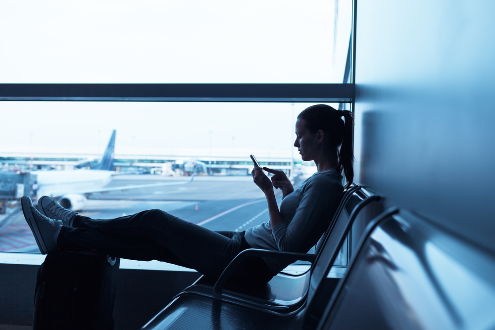 Person reading from their phone at an airport