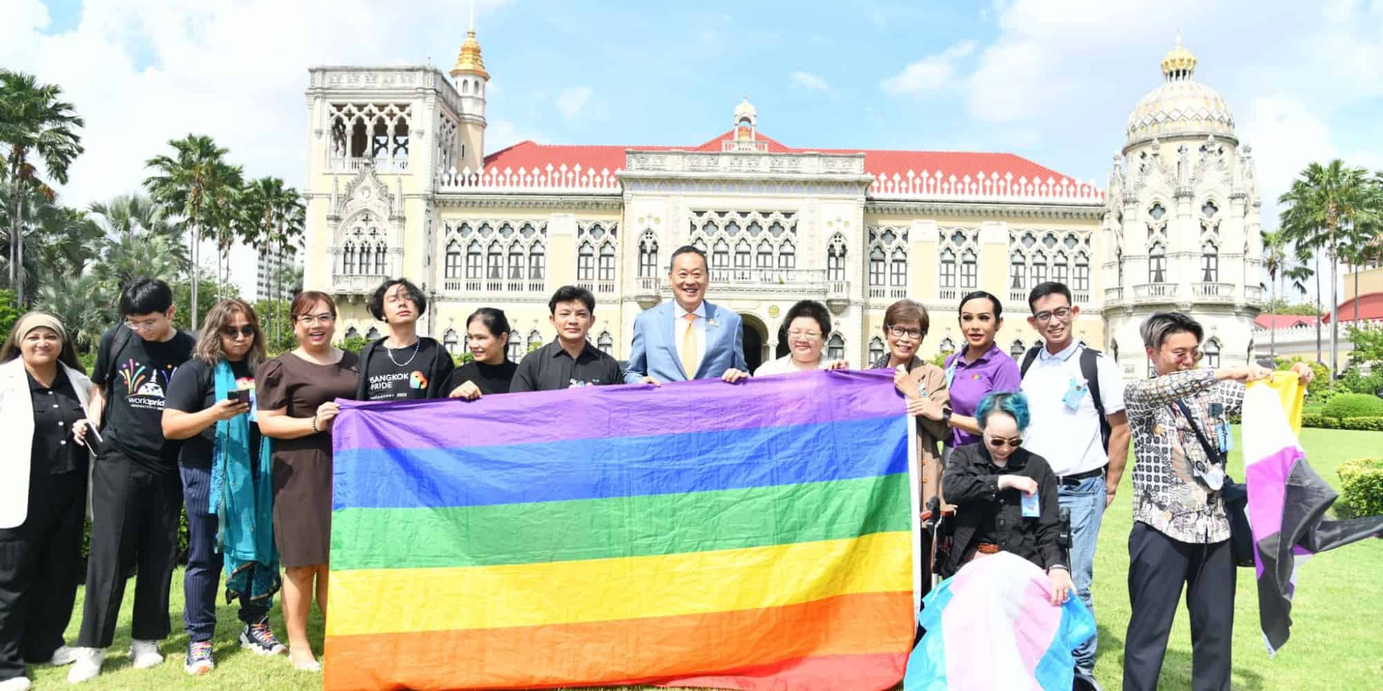 People holding rainbow flag