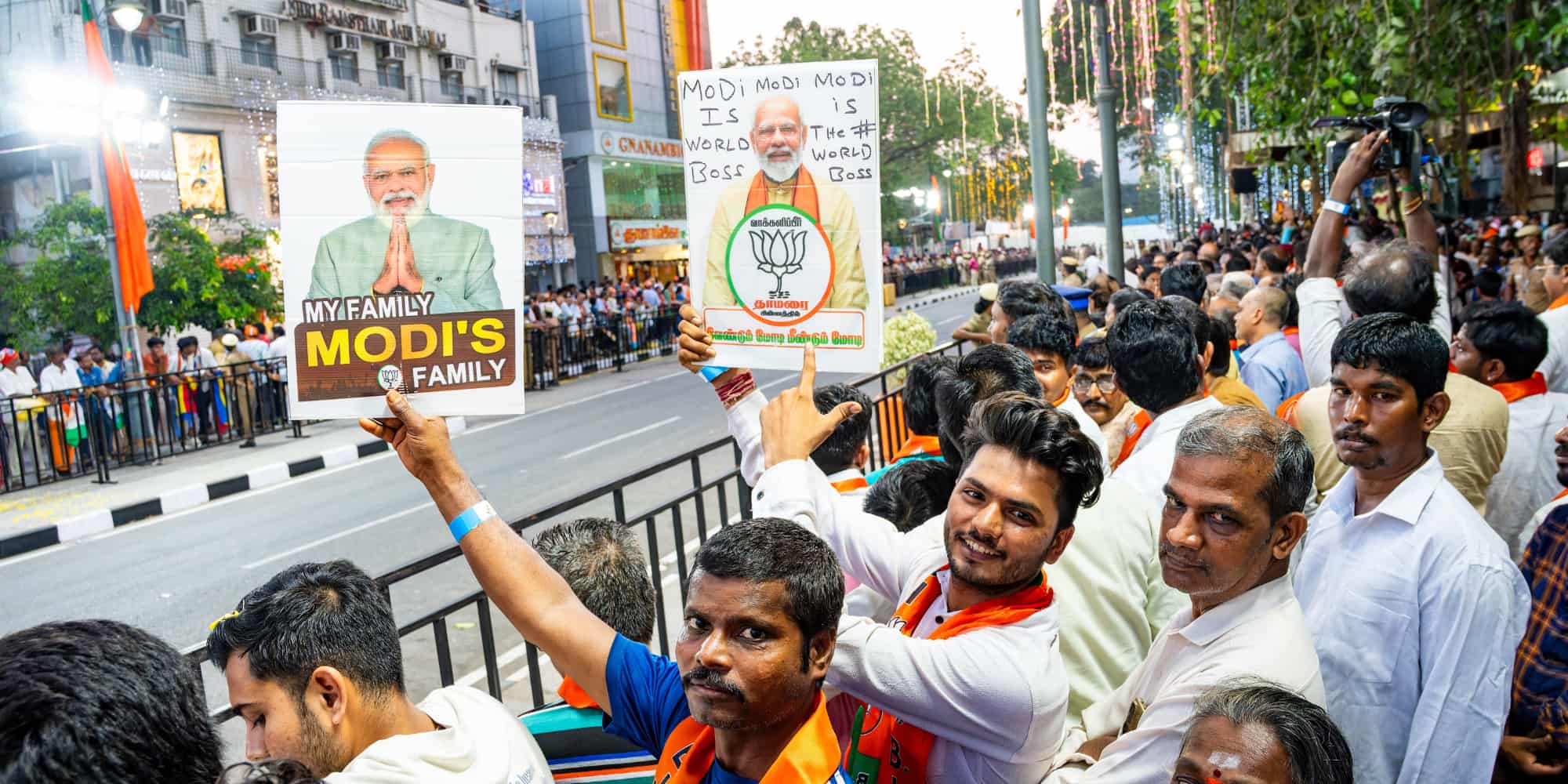 Indian men show signage supporting Modi