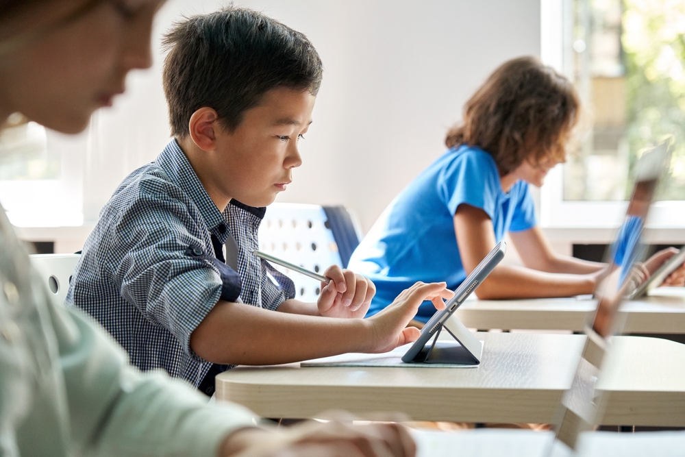 children learning on laptops