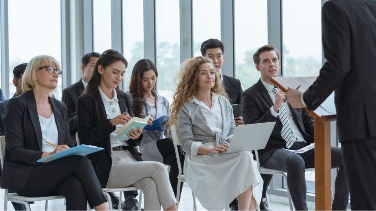 Group of diverse audience listening to a speaker at a seminar