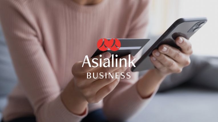 Hands holding credit card and mobile phone