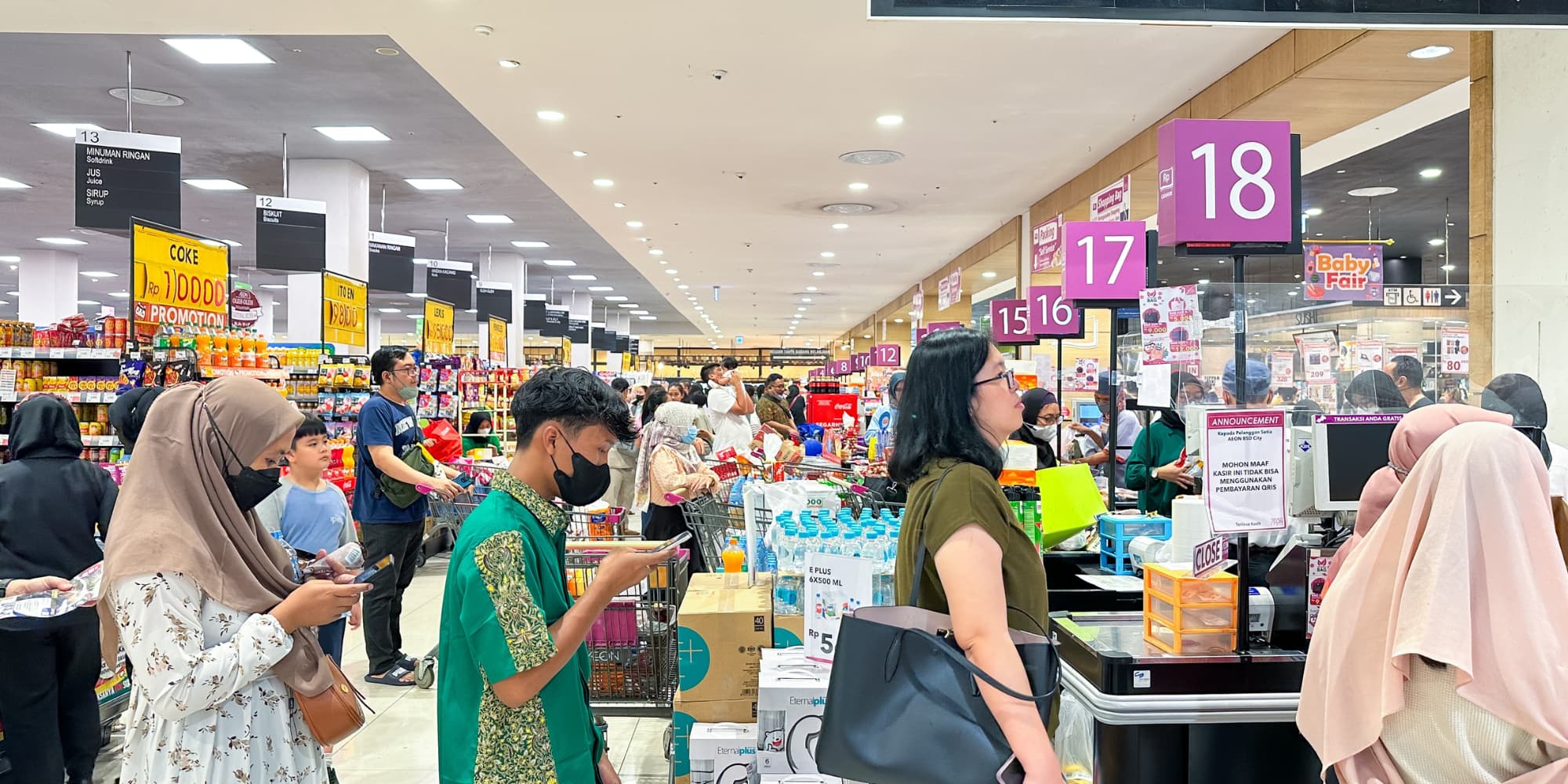 Customers line up at checkout in a supermarket