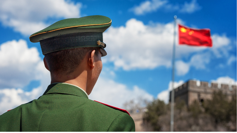 China soldier in front of great wall and chinese flag