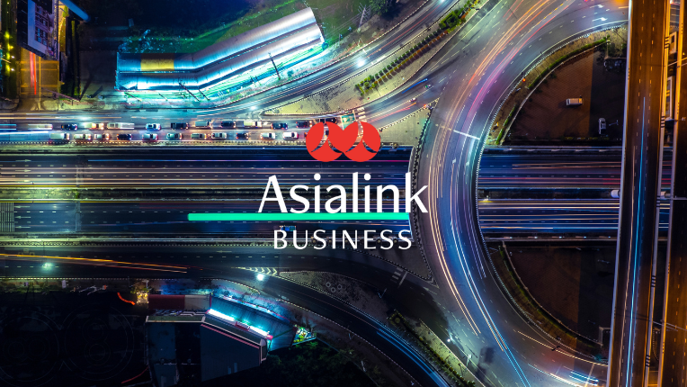 Busy flyover at night with Asialink Business logo superimposed