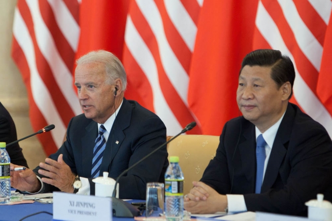 Joe Biden sits next to Xi a during the roundtable with US and Chinese business leaders at the Beijing Hotel in Beijing, China