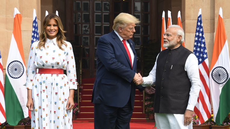 Trump and modi shake hands while melania looks on