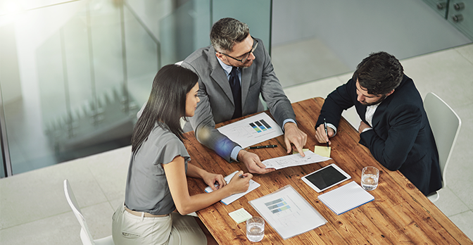 Staff gathered around a meeting table