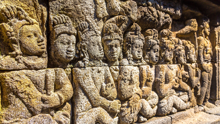 Relief of historical carvings on Buddist temple Borobudur near Yogyakarta
