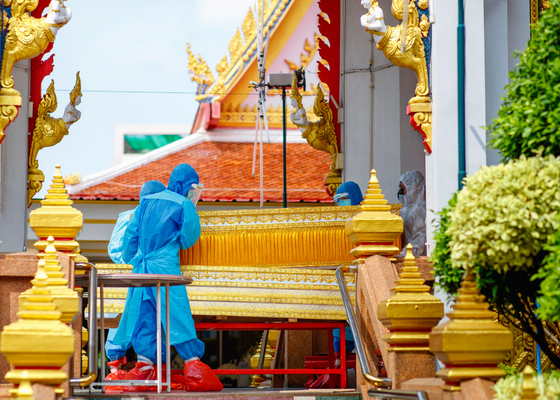 Emergency workers transport the deceased into COVID-only crematorium, Bangkok, Thailand
