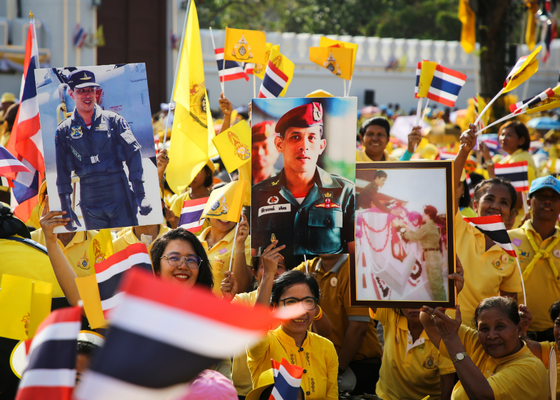 adoring crowds display images of King Maha Vajiralongkorn of Thailand while waiting for him to appear at the Grand Palace, Bangkok, Thailand