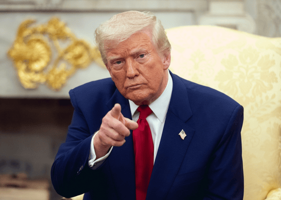 Donald Trump sitted, pointing at someone during a press conference