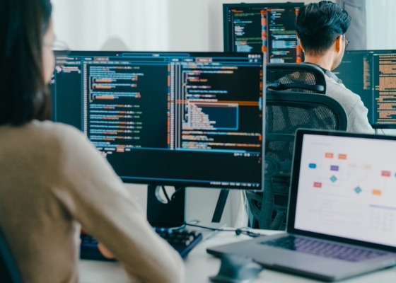 two people working on computers